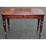 A Victorian mahogany table, with a moulded edge, on turned legs,
