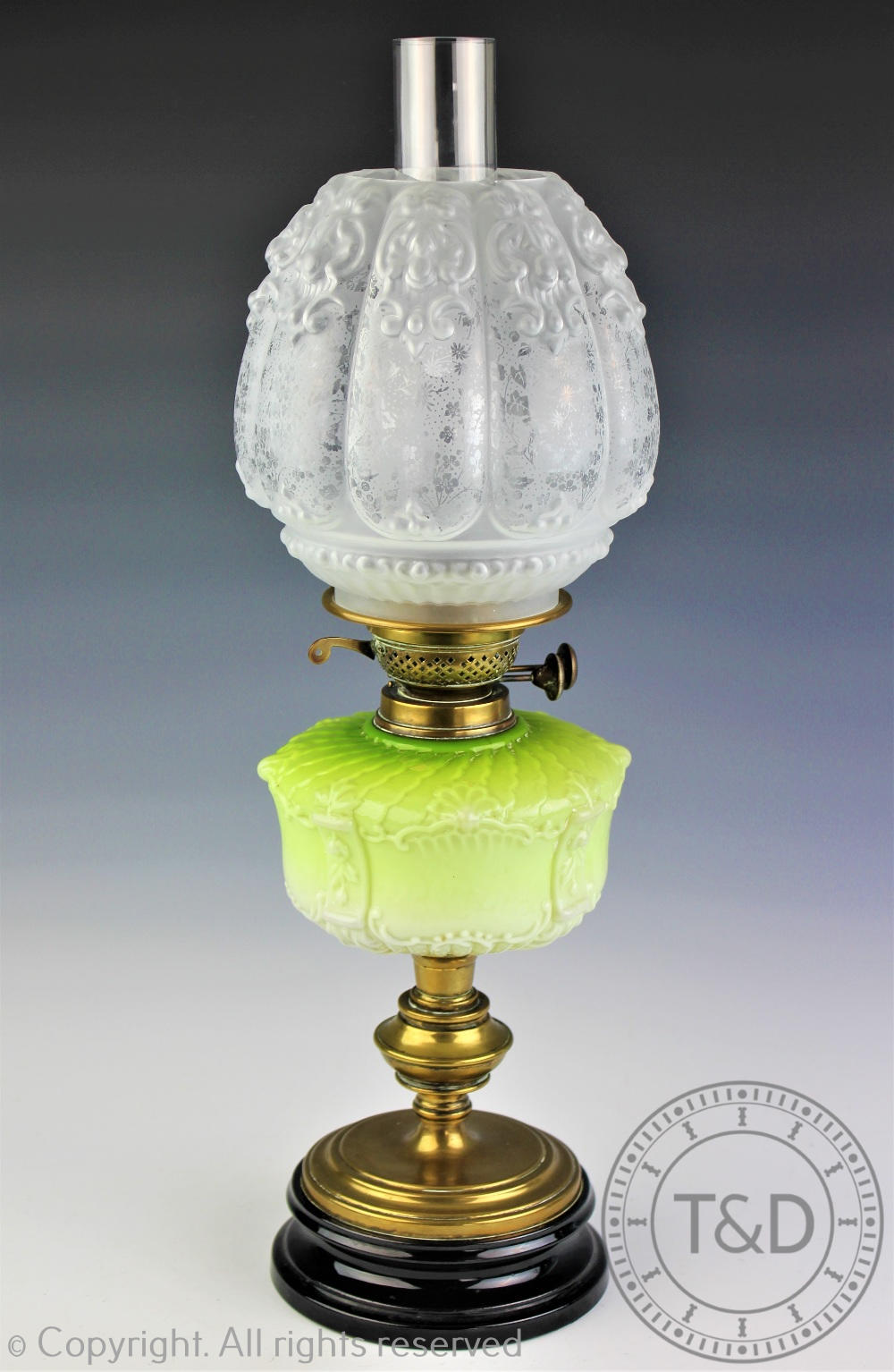 A Victorian oil lamp with green opaque glass reservoir,