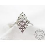 A diamond set ring, designed as a lozenge shaped panel set with sixteen brilliant cut diamonds,