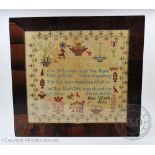 A Victorian needlework sampler by Sarah Butler dated 1860, worked with a verse, flowers,