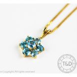 A topaz set floral pendant,