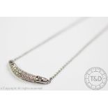 A diamond set necklace, designed as a central curved panel,
