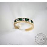 An emerald and diamond half eternity ring,