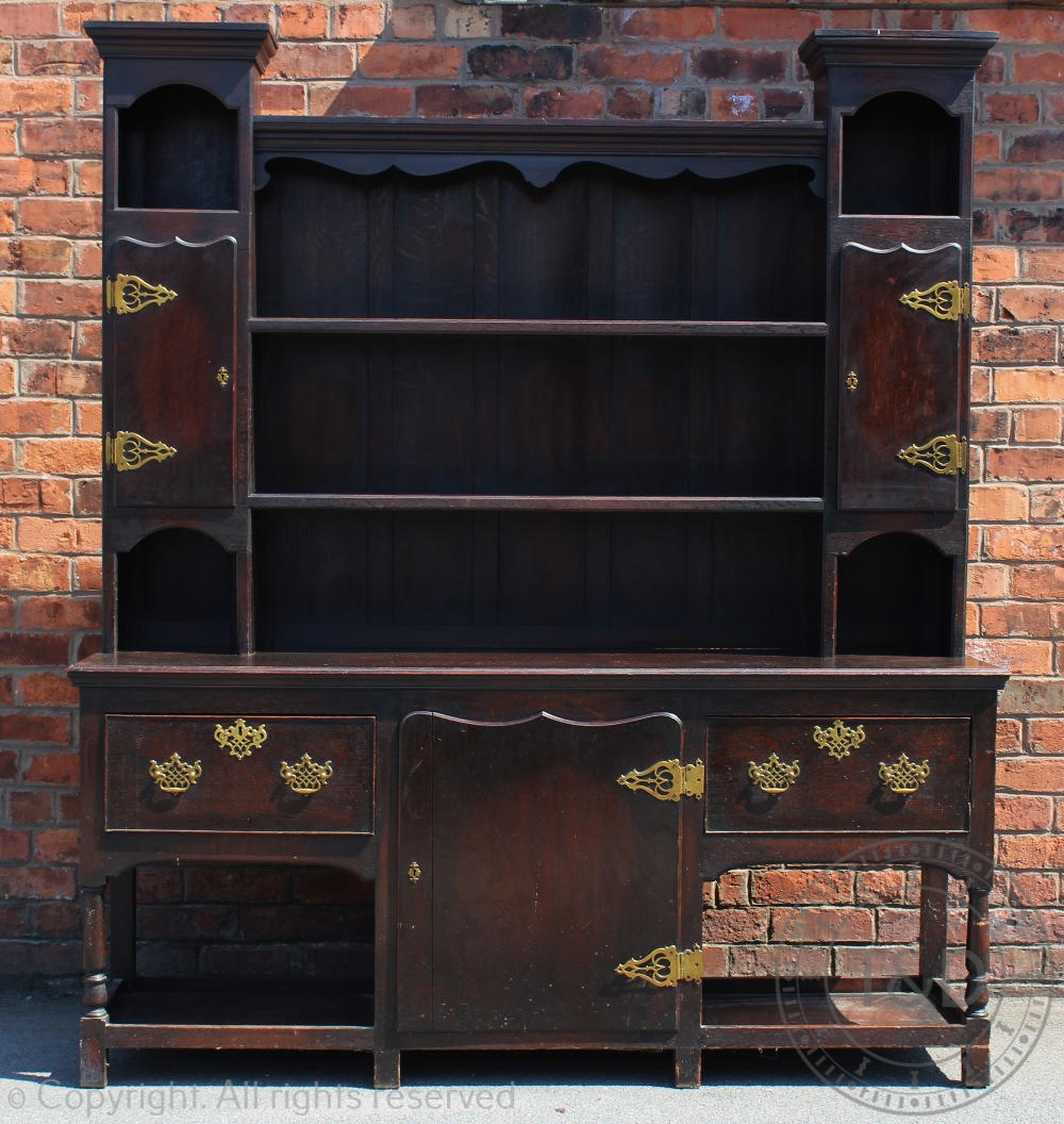 An 18th century style high back oak dresser,