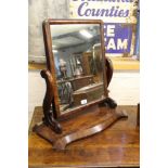 A Victorian mahogany toilet mirror, on serpentine base,