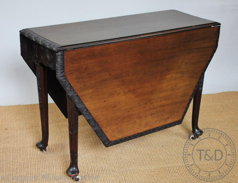 A George III and later carved mahogany gate leg table, on tapered legs with pad feet,