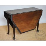 A George III and later carved mahogany gate leg table, on tapered legs with pad feet,