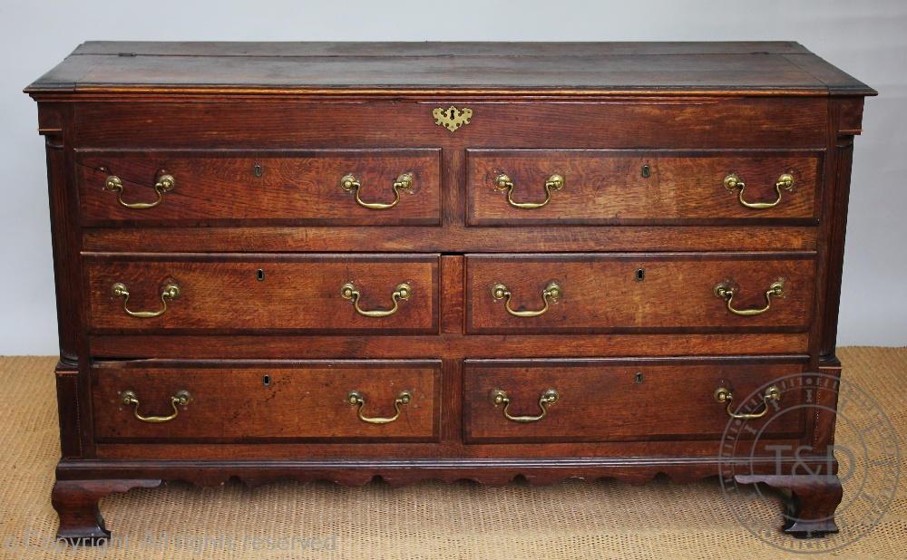 A George III oak and mahogany cross-banded mule chest, with hinged top above two dummy drawers,