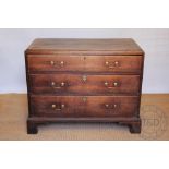 A George III oak chest, of three long drawers, on bracket feet,