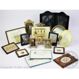 A collection of seventeen vintage photograph frames, including brass, treen and leather examples,