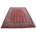 A Bokhara carpet, worked with rows of gulls against a red ground,