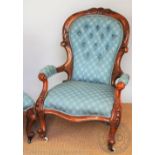 A Victorian carved walnut button back salon chair, with patterned blue upholstery,