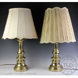 A pair of Dutch style brass lamp bases, each of baluster form on circular bases, with shades,