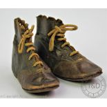 A pair of 19th century infant doll shoes, with leather soles and laces,