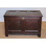 A late 17th century oak coffer, with panelled top, front and sides, on stile feet,