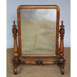A Victorian mahogany toilet mirror, with rectangular plate, on turned uprights and scroll legs,