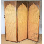 An oak three fold room divider / dressing screen, with bergere arched panels,