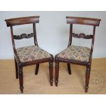 A set of six William IV mahogany dining chairs, with carved bar backs and drop in seats,
