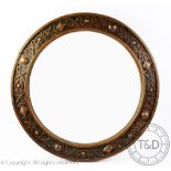 A 1920's carved oak circular wall mirror, 58cm diam,