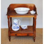 A Victorian mahogany two-tier wash stand, with base drawer, on turned legs,