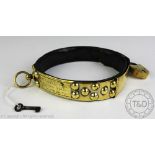 A Victorian brass and leather dog collar, the adjustable collar secured by a padlock,