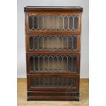 A Globe Wernicke style oak four section bookcase, with lead glazed doors,