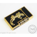 A Dupont gold coloured metal lighter with black lacquer and applied gold coloured and diamond set