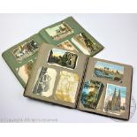 A collection of Edwardian and later postcards in two albums,