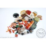 A quantity of assorted hardstone and other plaques, panels and beads, to include; agates,
