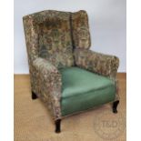 An 18th century style wing back library chair, early 20th century, with floral upholstery,