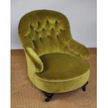 A late Victorian ebonised salon chair, with button back upholstery, on bun feet,