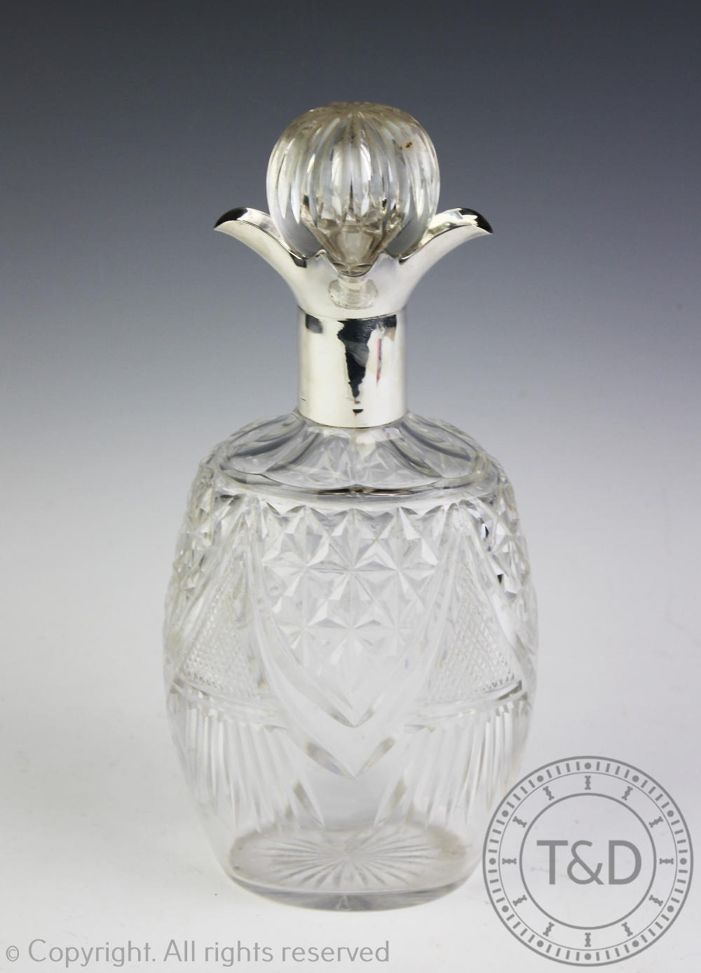 A George V silver mounted cut glass decanter and stopper, Sheffield, 1932, with four pouring lips,