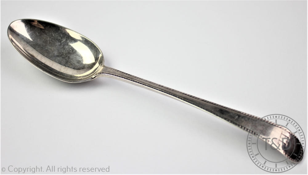 An Old English spoon with feather edge, bearing first duty mark (London 1 Dec 1784- 28th May 1785),