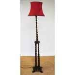 A 1920's oak standard lamp, with barley twist clustre column, on circular base,