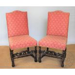 A pair of 17th century style carved and stained beech chairs, with upholstered backs and seats,