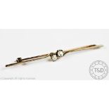 A diamond set bar brooch, set centrally with two diamonds in cross over setting,