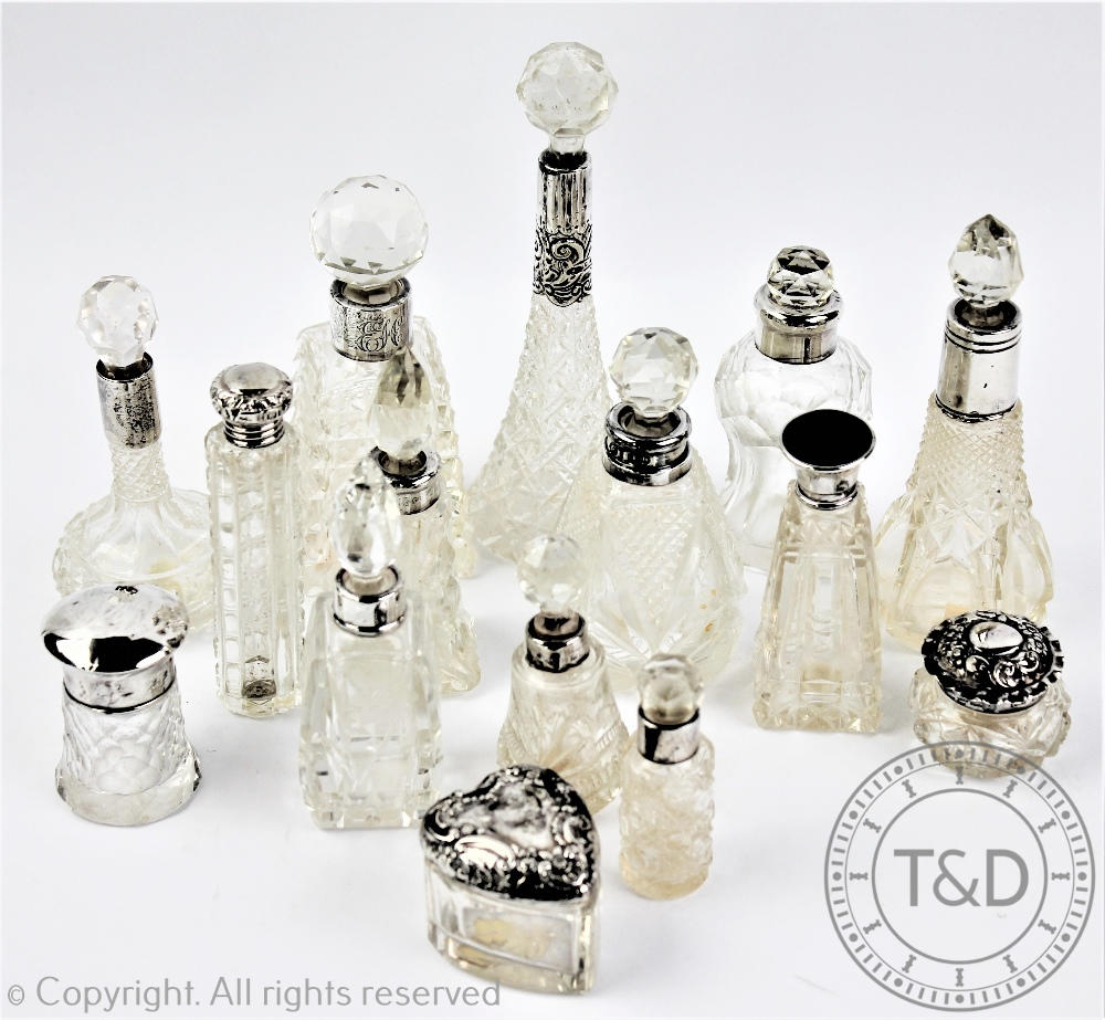 A collection of thirteen silver collared cut glass scent bottled and stoppers, tallest 15cm,