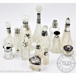 A collection of thirteen silver collared cut glass scent bottled and stoppers, tallest 15cm,