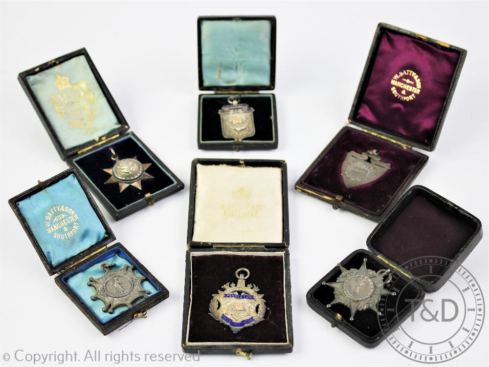 A selection of six silver and white metal sporting presentation fobs and club medals all awarded to
