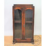 A 1920's oak two door bookcase, with glazed doors,