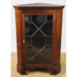 A 19th century mahogany corner cabinet, with astragal glazed door, on bracket feet,