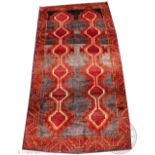 A Persian hand woven Lori carpet, worked with two rows of gulls in red and orange,