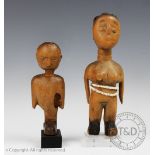 Two West African carved wood tribal art Ewe dolls, one with white beads, mounted, 22.5cm and 17.