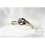 A two stone diamond and untested ruby ring, in cross-over collet setting, hoop stamped '18ct',