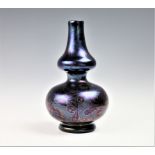 A Loetz glass double gourd vase, circa 1901, the iridescent body with leaf and berry pattern,