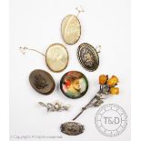 A collection of eight assorted brooches, to include; a circular brooch depicting a maiden,
