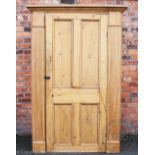 A George III style pine hall cupboard, with panelled door and fluted pilaster sides,