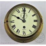A Smith Astral brass bulk head time piece, Roman numeral dial with subsidiary seconds,