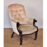 A Victorian carved mahogany button back salon chair, with scroll end arms, on turned legs,