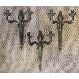 A set of three George III style brass twin branch wall lights, with flaming run back plates,